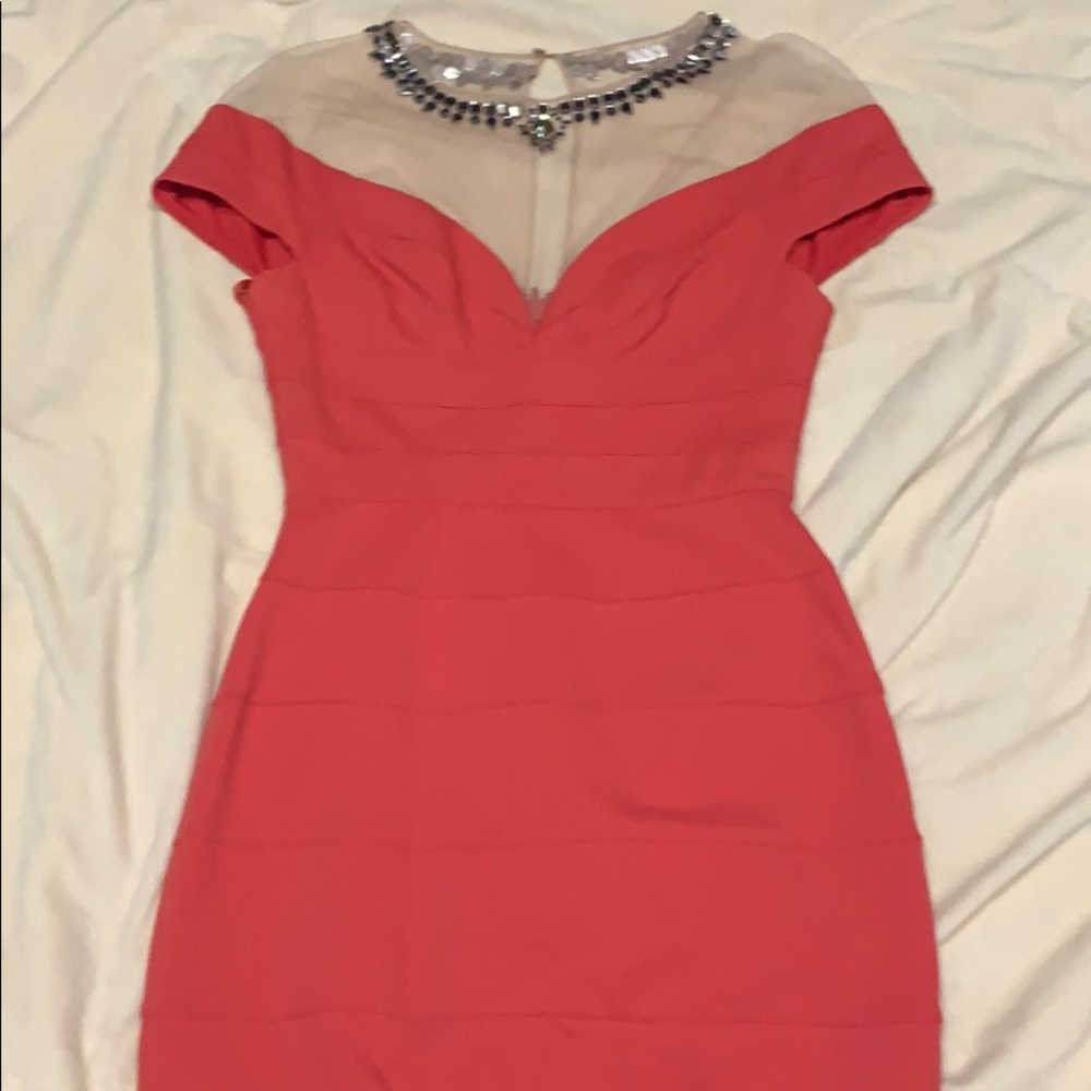 Turn heads in this coral, jeweled mini dress!